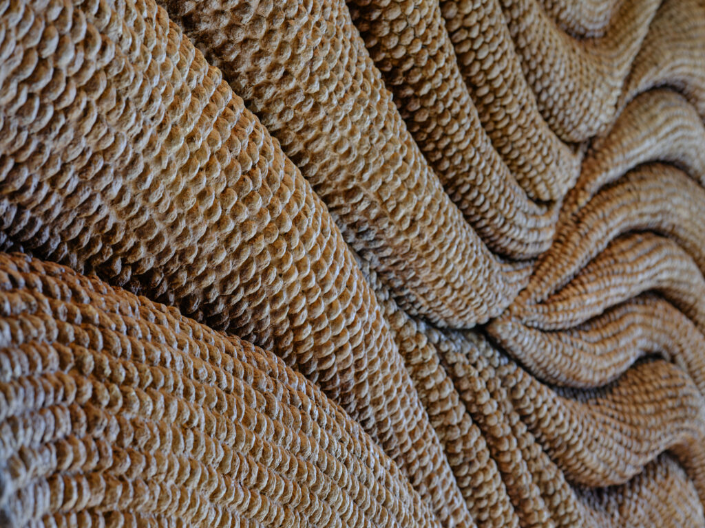 Textured sculptural installation creating spatial depth within architectural interior