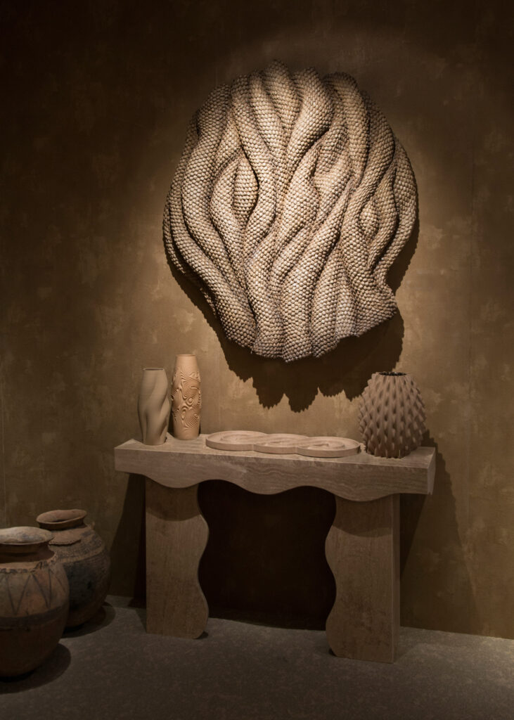 Large scale sculptural wall relief with mineral inspired textures in architectural interior