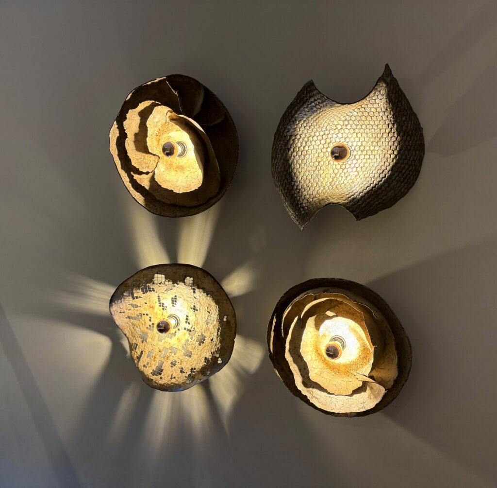 Illuminated relief installation creating a dialogue between textured material surfaces and light within an architectural interior 
