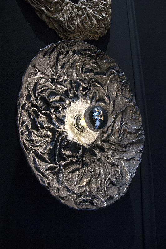 Hand-shaped material surface exploring geological forms.