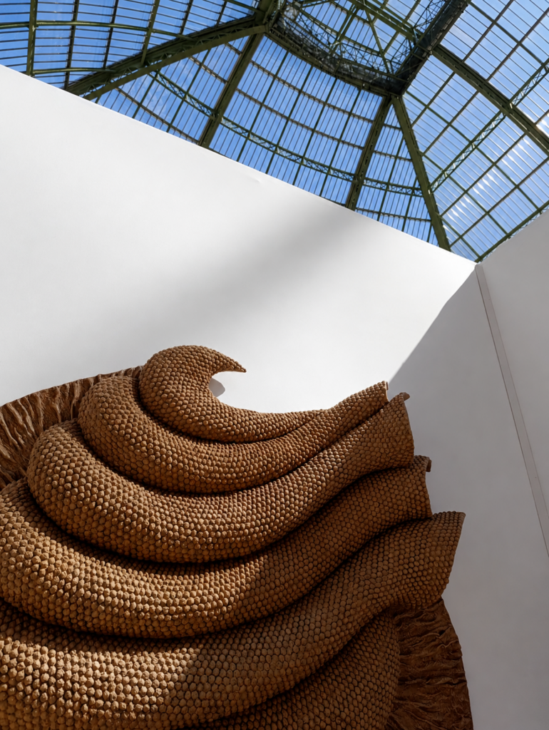 Monumental sculptural installation interacting with light and surrounding architecture.