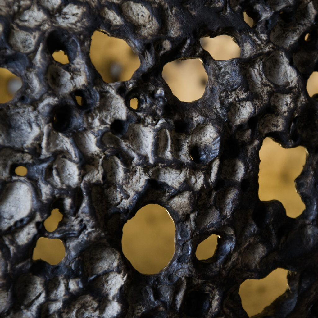 Sculptural artwork shaping the perception of space through texture and relief.