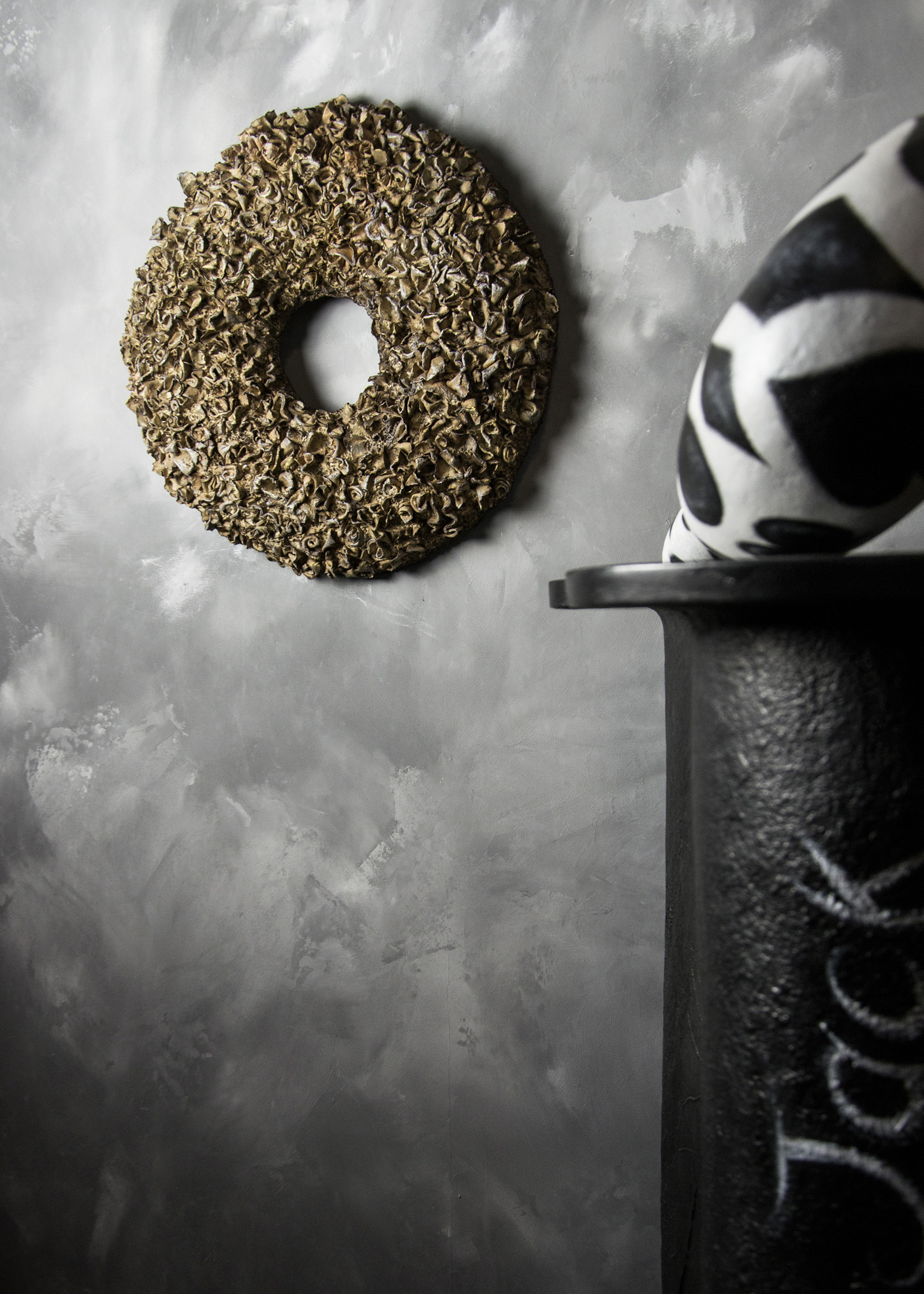 Sculptural installation with textured material surfaces designed for architectural interior space creating spatial presence in a contemporary interior