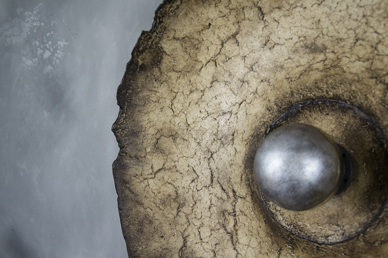 Sculptural wall piece combining texture, relief and integrated light.
